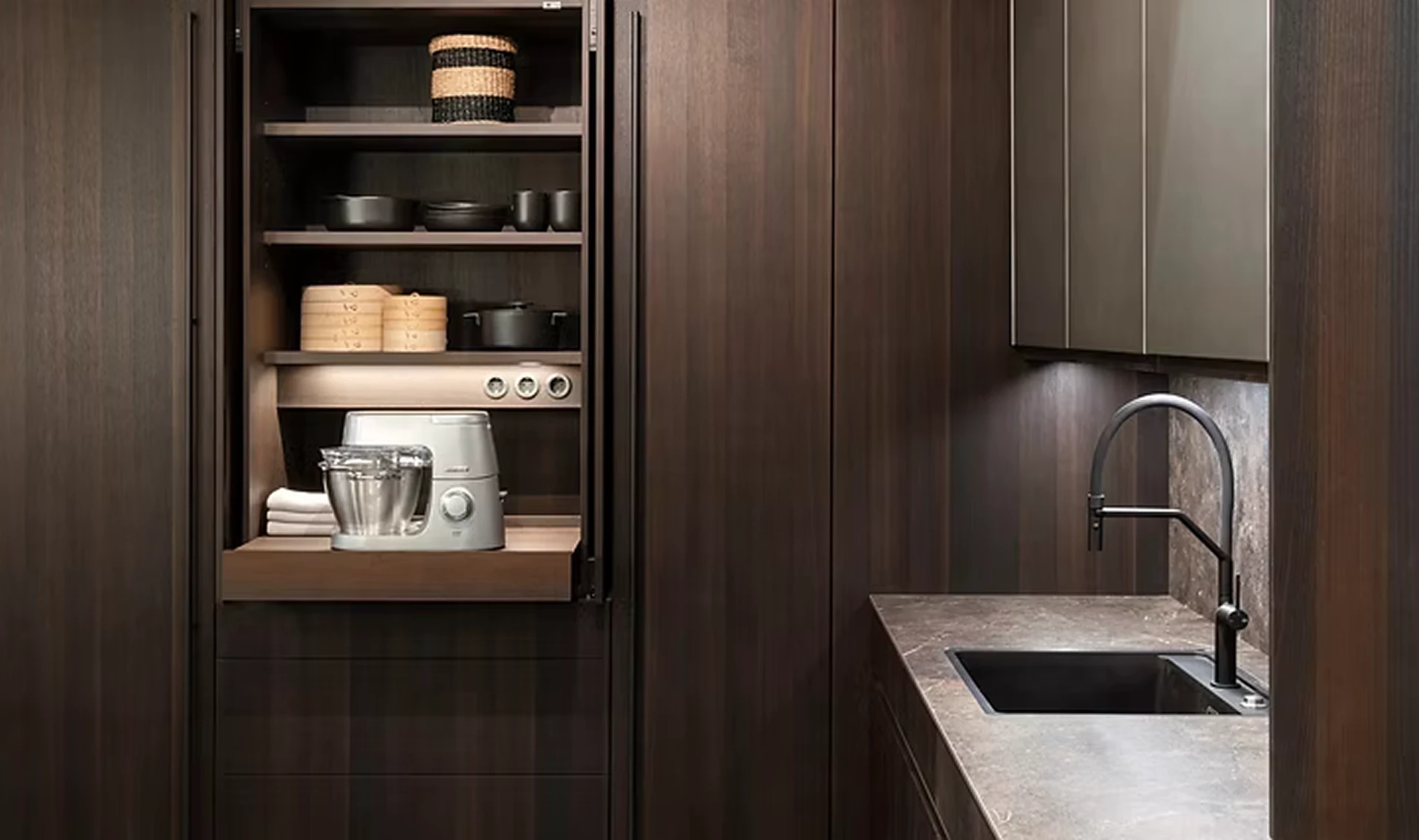 Luxury dark wood kitchen with integrated storage